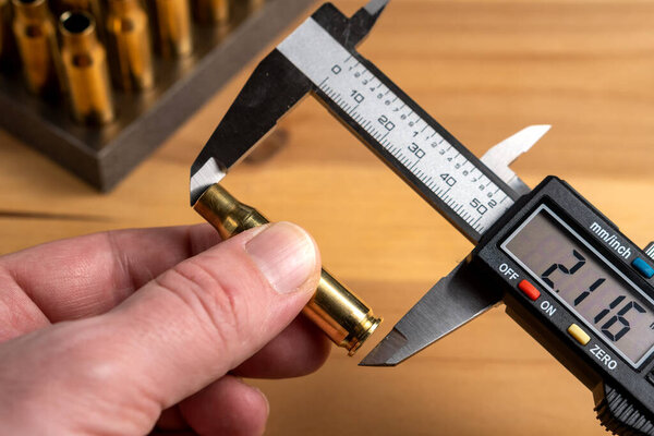 Production of cartridges for a rifle, reload. Measurement of the empty cartridges with a caliper