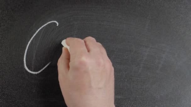 Covid-19. Man hand writes the word Covid-19 by chalk on a blackboard — Stock Video