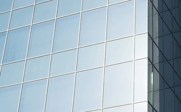 Geometric colored building facade elements with planes, lines and corners with light flare and reflections for an abstract background and texture of white, blue, gray colors. Place for text