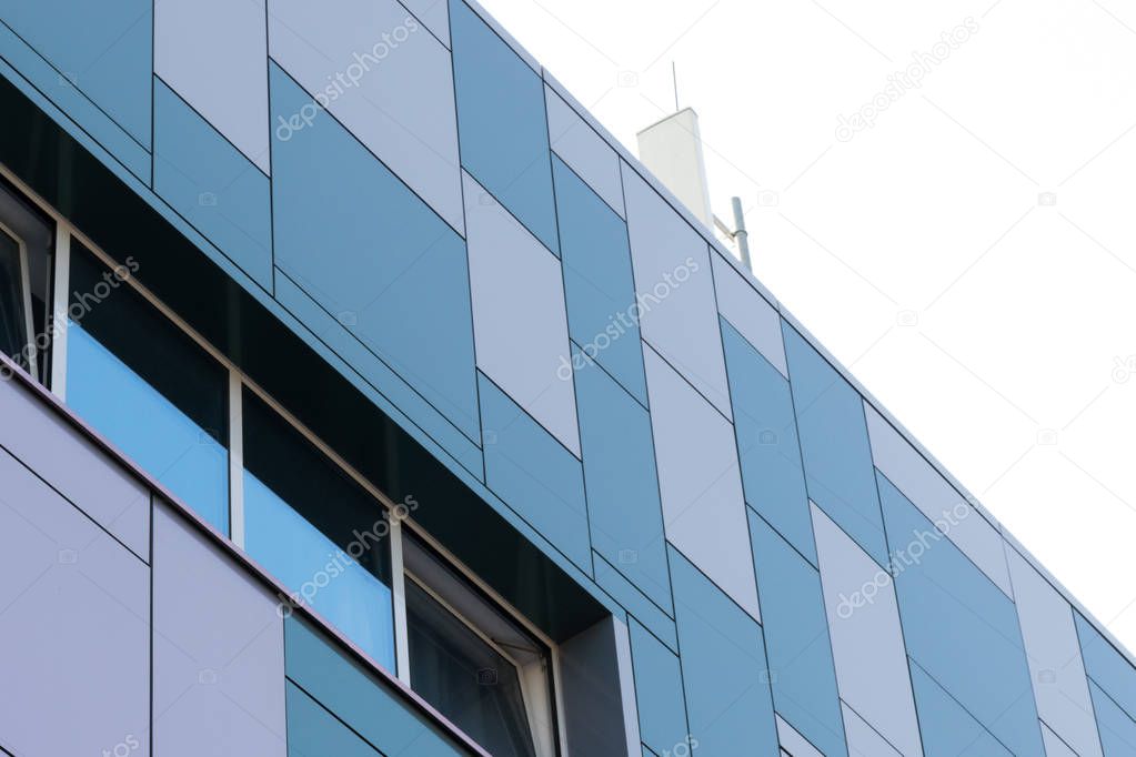 Geometric color elements of the building facade with planes, lines, corners with highlights and reflections for the abstract background and texture of white, turquoise, blue, gray colors. Place for text