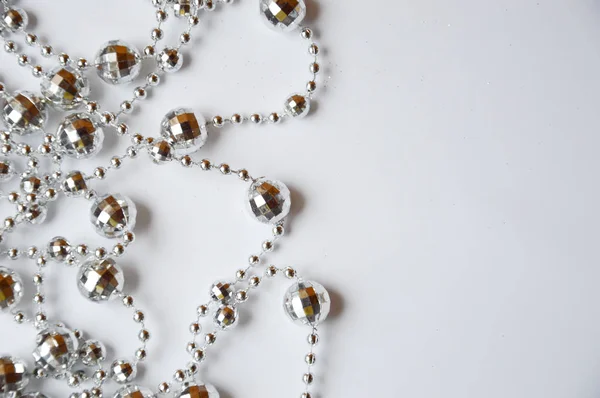 Beyaz arka planda iç dekorasyon için gümüş boncuklar. Tatil için dekorasyon. Mutlu Noeller ve mutlu yıllar..