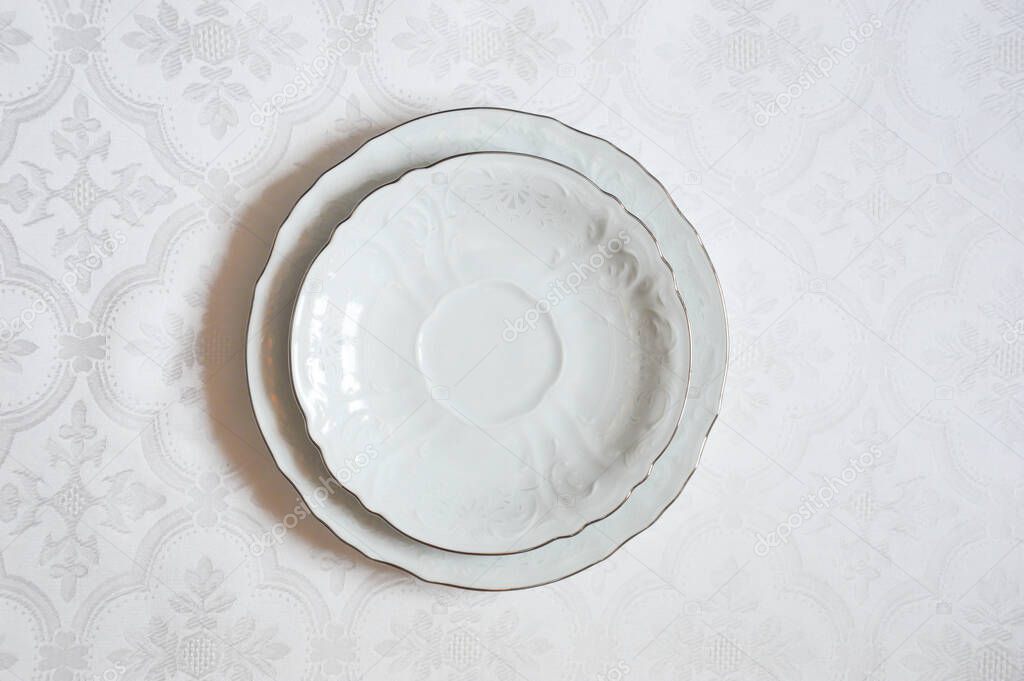 Two white dinner plates on a white background.