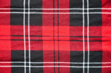 Kumaşın dokusu. Kırmızı ve siyah çizgili arkaplan.