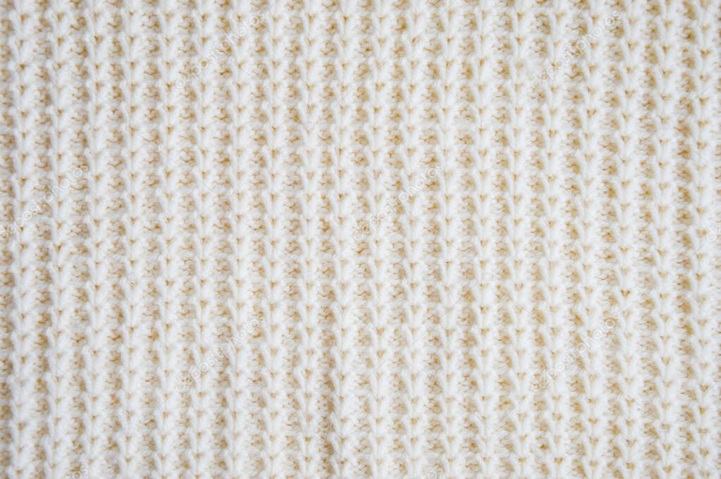 The texture of the fabric. White knitted pattern. background.