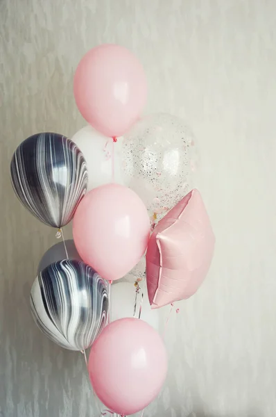 balloons on a light background. pink, white, and gray balloons. the decor of the occasion.