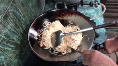 Wok Wook 'ta erişte pişiren adama yakın çekim.