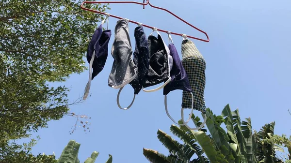 Cotton cloth mask hanging outdoor after the used and washing,natural glare light,the mask repeated use 2-3 times,after use every day should wash and dry in the sun to be sterilized as well,coronavirus