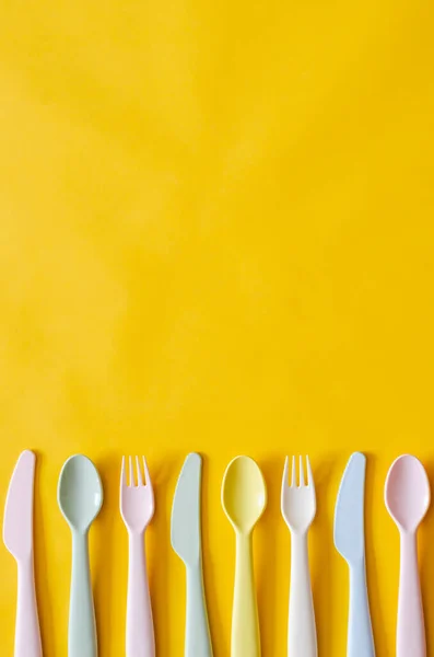 Colorful fork, spoon and knife on yellow background with empty space for text. — Stock Image Colorful Fork Spoon Knife Yellow Background Empty Space Text Stock Picture
