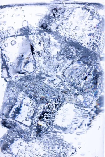 Background of ice cubes doused with mineral water with air bubbles — 스톡 사진