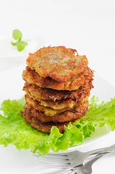 Fried potato pancakes, stacked on plate Royalty Free Stock Photos