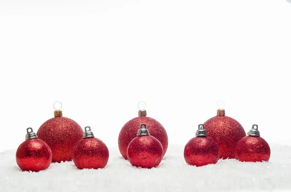 Red christmas balls lying on snow Stock Photo