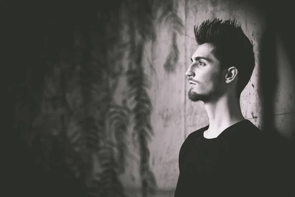 young man in profile, black and white with copy space