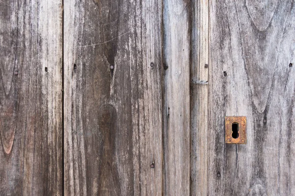 Close up of a handle on the old wooden door in an abandoned hous — Stock Photo, Image
