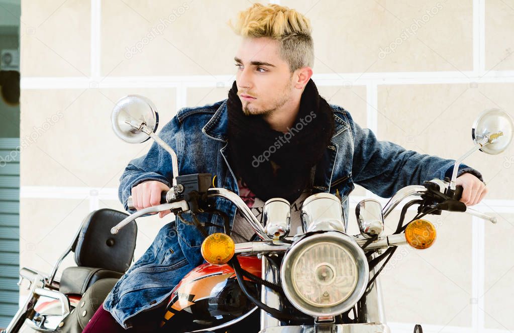 Handsome fashion man sitting on classical motorcycle.