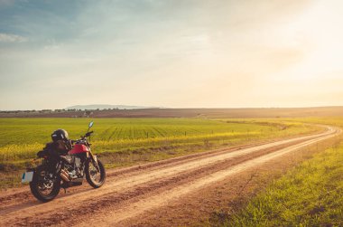 Motorbike on road  with open sky on background. clipart