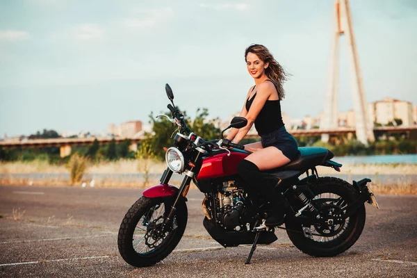 beautiful young woman riding on a motorcycle