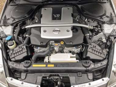 Portland, Oregon / USA - circa 2019: V6 3.5L engine under the hood of a Nissan 350Z. clipart