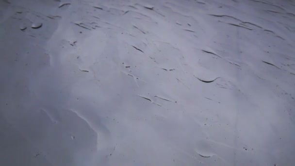 Drops of water on a glass window, rainy weather on a windy day — Stock Video