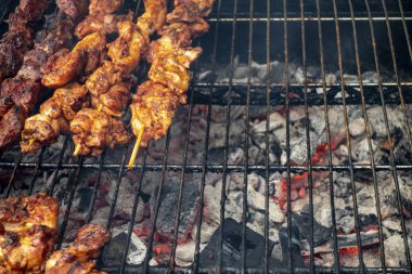 Overhead view of marinaded chicken skewers on outdoor backyard w