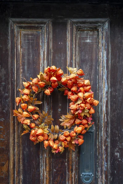 Front door welcome fall flower reef hanging on old apparement door