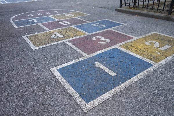 hop-scotch childern's game on school yard asphalt with colored squares