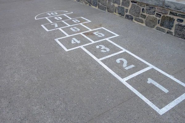 hop-scotch childern\'s game on school yard asphalt painted lines and numbers