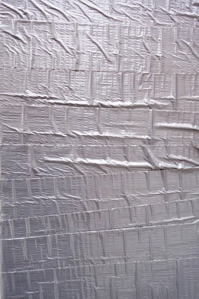 textured tape wall covered with silver duck tape