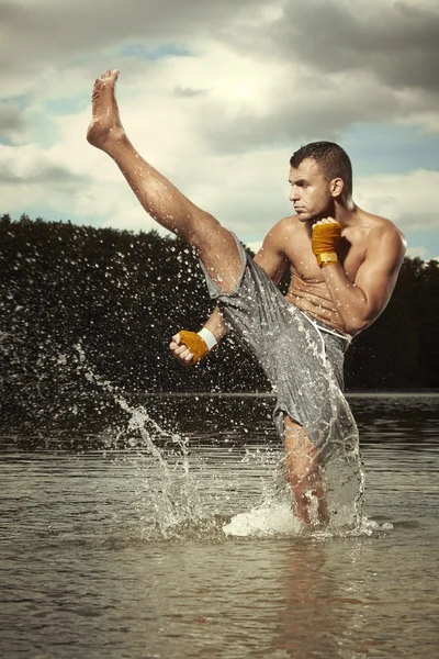 Champion kickboxer training fights in water — Stock Photo, Image