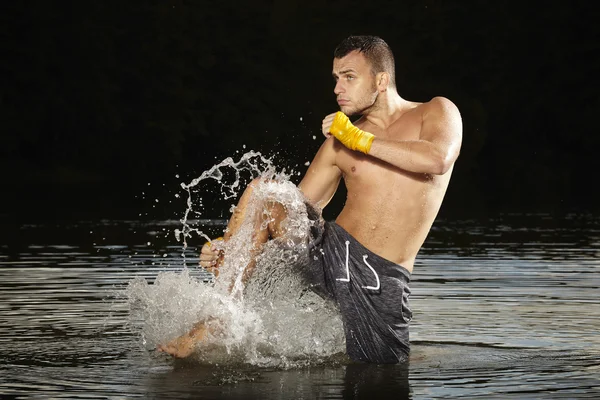 Champion kickboxer training in water — Stock Photo, Image