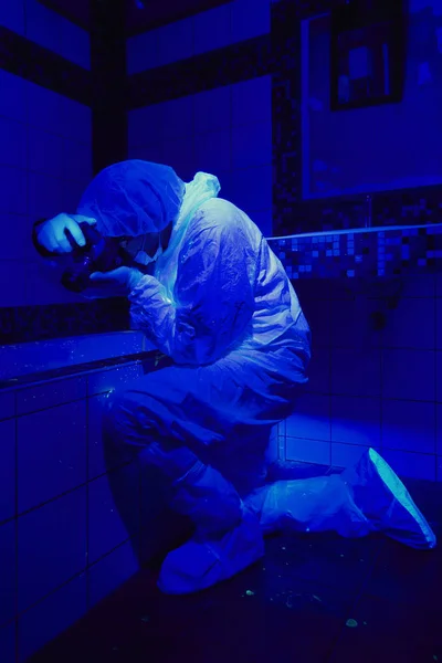 Technicien travaillant sous la lumière UV sur le lieu de la criminalité — Photo