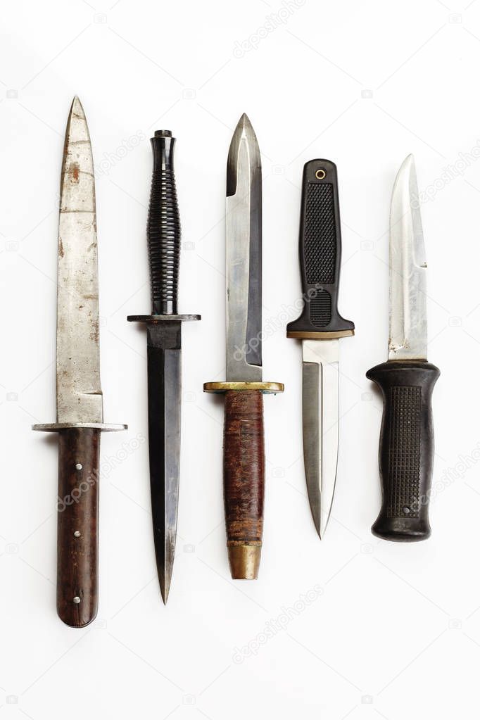 Combat knives and daggers on white background
