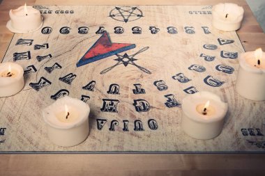 Ouija for communicating with human ghosts clipart