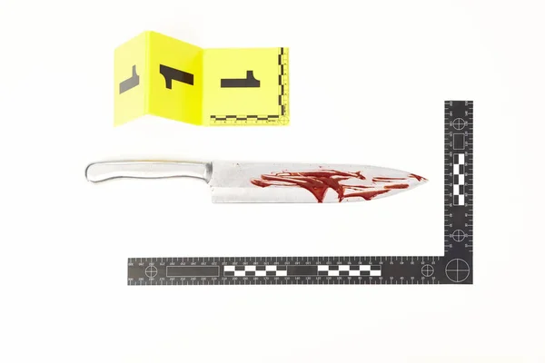 Bloody full metal knife with measure scale as evidence of violent crime — Stock Photo, Image