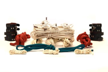 Lot of ropes, vibrators and handcuffs for BDSM games clipart