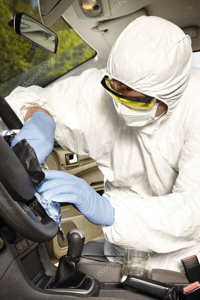 Collecting of odor traces by criminologist technician from driving wheel
