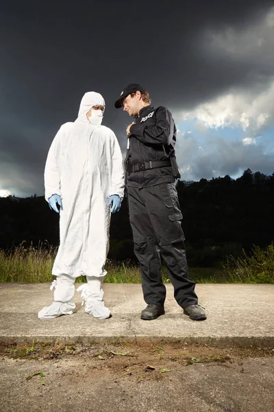 Técnico criminólogo con policía en el lugar del crimen — Foto de Stock