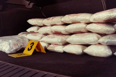 Police documentation of place of crime - drugs in car trunk found clipart
