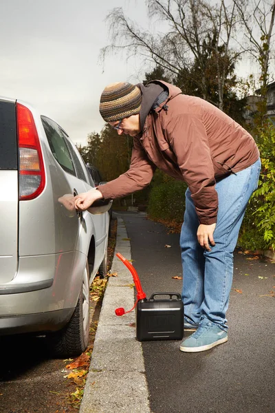 Driver filling car tank from plastic canister — Stock Photo, Image