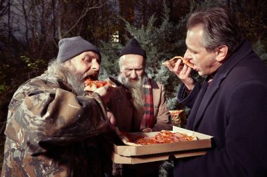 Man in suit met two homeless men in winter park and ordering pizza clipart