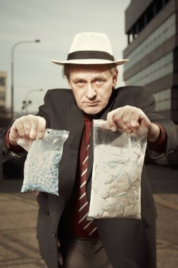 Older dealer of narcotics selling drugs on street clipart