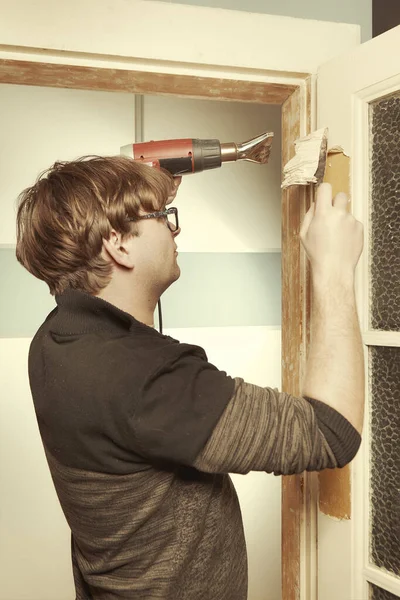 Mężczyzna Domu Usuwając Owłosioną Warstwę Starej Farby Drzwi — Zdjęcie stockowe