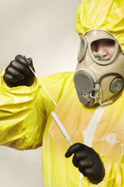 Virüse karşı koruyucu giysi uzmanı test için mukoza sıvısı alıyor.