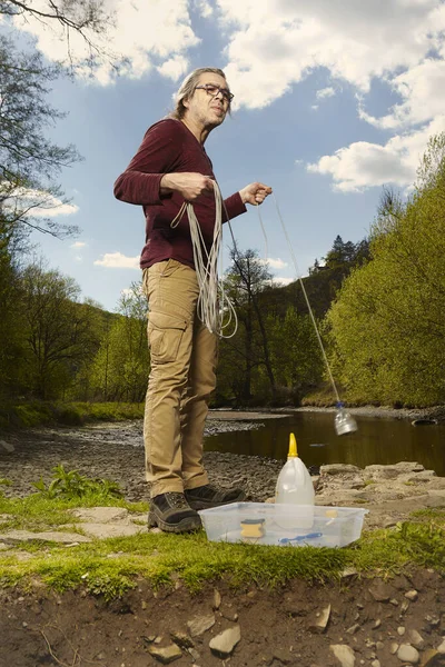 Man Trying Explore River Water Neodymium Magnet Find Something Iron — Stock Photo, Image