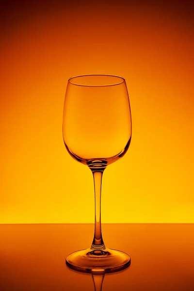 Wine glass on a yellow-orange background with a gradient