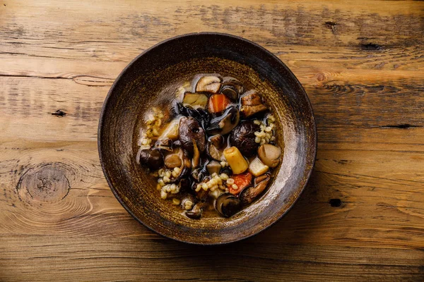 Healing Soup with roots, mushrooms and barley on wooden table background — Stock Image Healing Soup Roots Mushrooms Barley Wooden Table Background Royalty Free Stock Images