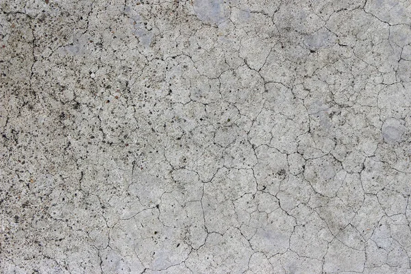 Yaş olarak çatlamış beton alçı duvar arkaplanı ve doku biçimi