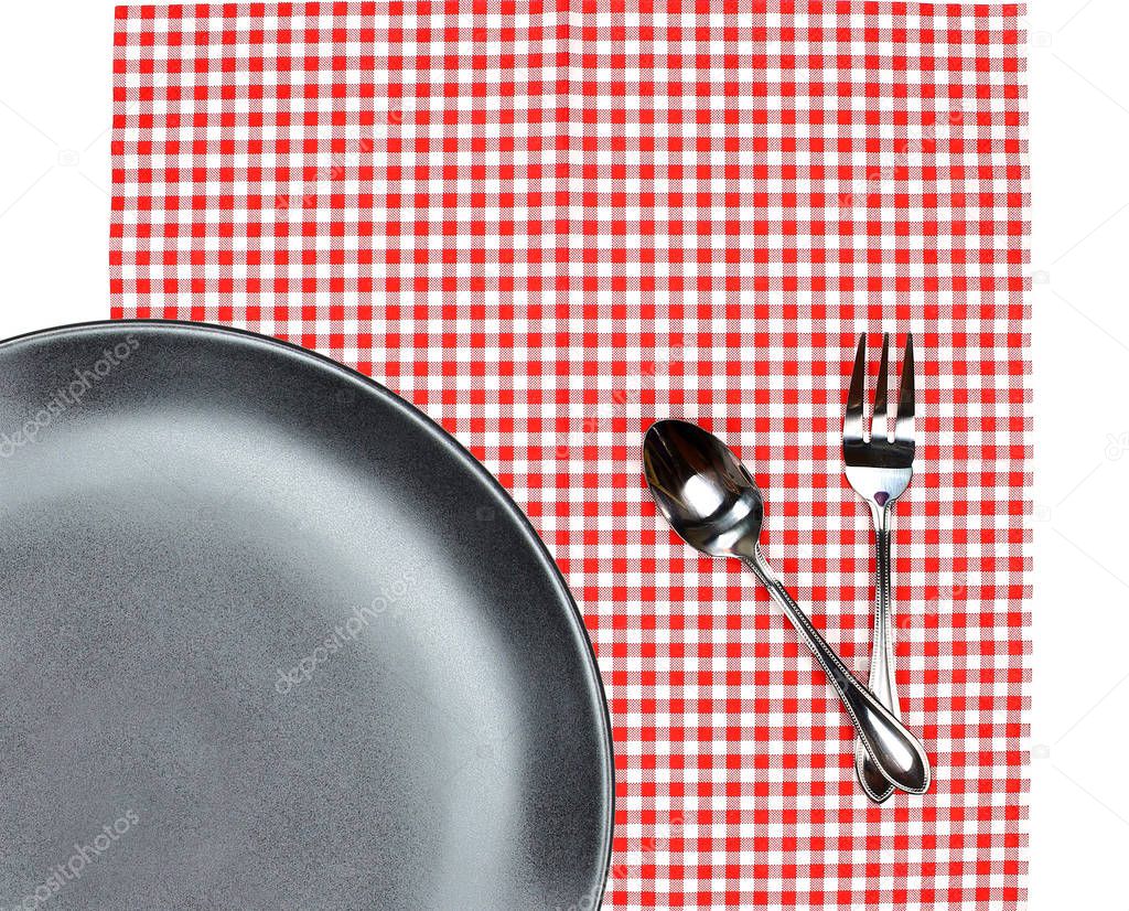 Top view plate with fork and spoon on tablecloth for food servin