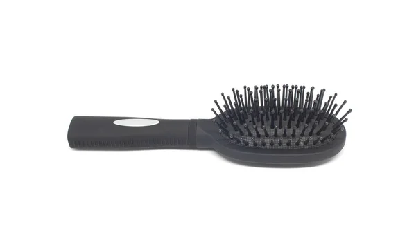 Black hairbrush on white background — Stock Photo, Image