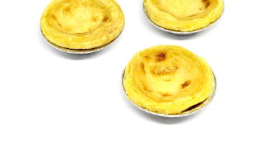 Beyaz arka planda yumurta kremalı tart.