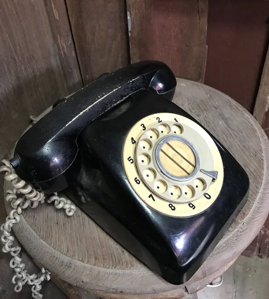 Black vintage telephone on wood — Stock Photo, Image